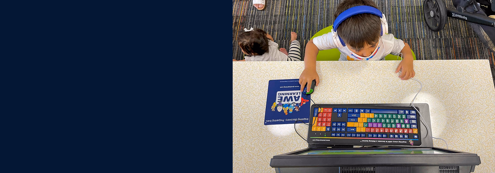 Young student using assistive learning technology and an adaptive keyboard